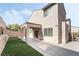 Spacious backyard showcasing a covered patio, artificial turf, and privacy, ideal for entertaining and relaxing at 2482 Denholme St, Henderson, NV 89044