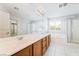 Bright bathroom with double sinks, a soaking tub, and a separate glass-enclosed shower at 2482 Denholme St, Henderson, NV 89044