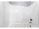 Shower tub combo with white tile surround, faucet, and a shower head at 2482 Denholme St, Henderson, NV 89044