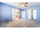 Bedroom with neutral carpet, ceiling fan, and access to the attached bathroom at 2482 Denholme St, Henderson, NV 89044