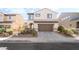 Charming two-story home featuring desert landscaping and a two-car garage at 2482 Denholme St, Henderson, NV 89044