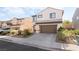 Charming two-story home featuring desert landscaping and a two-car garage at 2482 Denholme St, Henderson, NV 89044