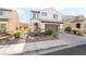 Charming two-story home featuring desert landscaping and a two-car garage at 2482 Denholme St, Henderson, NV 89044