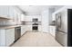 Bright kitchen featuring stainless steel appliances, white cabinetry, and neutral countertops for a sleek, modern feel at 2482 Denholme St, Henderson, NV 89044