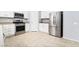 Well-lit kitchen features stainless steel appliances and white cabinets offering a blend of style and functionality at 2482 Denholme St, Henderson, NV 89044