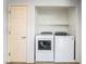 Laundry room with door, washer, dryer, and overhead shelf at 2482 Denholme St, Henderson, NV 89044