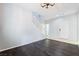 Spacious room with hardwood floors, a white staircase, and neutral paint at 2482 Denholme St, Henderson, NV 89044