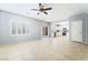 Open concept living space with tile floors, a fan, and a white kitchen at 2482 Denholme St, Henderson, NV 89044