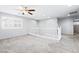 Bright upstairs loft area features neutral carpeting, a ceiling fan, window with shutters, and ample natural light at 2482 Denholme St, Henderson, NV 89044