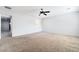 Spacious primary bedroom featuring neutral carpeting, a ceiling fan, and ensuite bathroom at 2482 Denholme St, Henderson, NV 89044