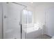 Bathroom boasts a glass shower, soaking tub and bright natural light from the window at 25 Barbara Ln # 57, Las Vegas, NV 89183
