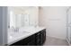 Bathroom features a dual sink vanity with dark cabinets and a walk-in glass shower at 25 Barbara Ln # 57, Las Vegas, NV 89183