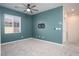Bedroom with neutral carpet, fan, and blue accent wall at 25 Barbara Ln # 57, Las Vegas, NV 89183