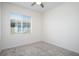 This bedroom features neutral carpet and a bright window at 25 Barbara Ln # 57, Las Vegas, NV 89183
