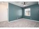 Bright bedroom with ceiling fan, neutral carpet, and access to closet and bathroom at 25 Barbara Ln # 57, Las Vegas, NV 89183