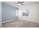 Well-lit bedroom featuring neutral carpet, ceiling fan, and bright windows at 25 Barbara Ln # 57, Las Vegas, NV 89183