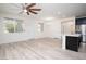 Bright, open-concept living area with new hard surface floors and ceiling fan at 25 Barbara Ln # 57, Las Vegas, NV 89183
