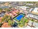 Aerial perspective of a tennis court surrounded by mature trees and residential buildings, highlighting recreational amenities at 2583 Egret Cir, Las Vegas, NV 89121
