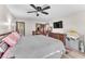 Comfortable bedroom with ceiling fan, TV, walk-in closet, and wood-look floors at 2583 Egret Cir, Las Vegas, NV 89121