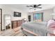 Bright bedroom featuring a large window, ceiling fan, and wood-look floors at 2583 Egret Cir, Las Vegas, NV 89121