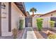 Home entrance featuring a secure black iron gate and well-maintained desert landscaping at 2583 Egret Cir, Las Vegas, NV 89121