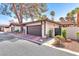 Charming home featuring a two-car garage, red tile roof, and desert landscaping at 2583 Egret Cir, Las Vegas, NV 89121