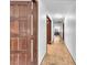 Hallway featuring parquet flooring, fresh paint, and access to multiple rooms at 2583 Egret Cir, Las Vegas, NV 89121