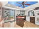 Bright kitchen with an island, stainless steel appliances, and a sliding glass door to the patio at 2583 Egret Cir, Las Vegas, NV 89121