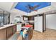 Kitchen features dark cabinets, a center island, stainless steel appliances, and natural light at 2583 Egret Cir, Las Vegas, NV 89121