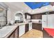 Kitchen with stainless steel appliances, dark cabinets, and an open layout to the dining area at 2583 Egret Cir, Las Vegas, NV 89121