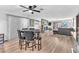 Open-concept living and dining area with a fireplace, ceiling fan, and sliding glass doors at 2583 Egret Cir, Las Vegas, NV 89121
