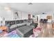 Open living room with gray sectional and a view of dining area, featuring stylish decor and natural light at 2583 Egret Cir, Las Vegas, NV 89121