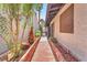Landscaped side yard with brick pathway and mature trees at 2583 Egret Cir, Las Vegas, NV 89121