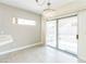Bright dining area featuring a modern light fixture and sliding glass door to the backyard at 2605 Memphis Ave, Henderson, NV 89052