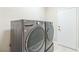 Laundry room with front loading washer and dryer next to a white door at 2605 Memphis Ave, Henderson, NV 89052