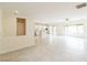 Open floorplan living room with tile flooring, natural light, and views of the kitchen and backyard at 2605 Memphis Ave, Henderson, NV 89052