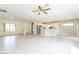 Spacious living room featuring tile floors, a ceiling fan, and an open layout to the kitchen and dining area at 2605 Memphis Ave, Henderson, NV 89052