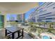 Enjoy outdoor dining on the balcony with sleek glass railings and scenic views of lush landscaping and city buildings at 2747 Paradise Rd # 501, Las Vegas, NV 89109