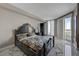 Stylishly appointed bedroom featuring a black carved bed, a private balcony, and sleek marble floors, offering elegant living at 2747 Paradise Rd # 501, Las Vegas, NV 89109