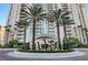 Beautifully landscaped entrance with palm trees framing a modern high-rise, conveying luxury and sophistication at 2747 Paradise Rd # 501, Las Vegas, NV 89109
