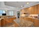 Open kitchen with granite countertops, wooden cabinets, and stainless steel appliances at 2747 Paradise Rd # 501, Las Vegas, NV 89109