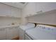 Bright laundry room with white cabinets, sink, counter, and washer and dryer for convenient home chores at 2747 Paradise Rd # 501, Las Vegas, NV 89109