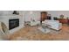 Spacious living room with tiled flooring, fireplace, white sofas, and ornamental wood armoire at 2747 Paradise Rd # 501, Las Vegas, NV 89109