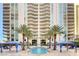 Beautiful pool with palm trees and covered lounge area in front of the condo building at 2747 Paradise Rd # 501, Las Vegas, NV 89109