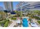 Stunning aerial view of the resort style pool and amenity spaces surrounded by lush landscaping and mature palms at 2747 Paradise Rd # 501, Las Vegas, NV 89109