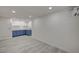 Finished basement with light gray tile flooring, a white door, and cabinets with a sink at 2839 Boise St, Las Vegas, NV 89121