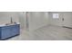 Finished basement features gray tile flooring, cabinets with a sink, and a doorway at 2839 Boise St, Las Vegas, NV 89121
