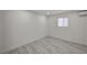Finished basement with light gray flooring, a white door, and a window at 2839 Boise St, Las Vegas, NV 89121