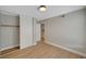 Bedroom featuring a closet with sliding doors, wood-look floors, light grey walls, and white trim at 2839 Boise St, Las Vegas, NV 89121