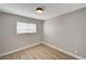 Cozy bedroom with wood-look floors, light grey walls, and a window with blinds for natural light at 2839 Boise St, Las Vegas, NV 89121